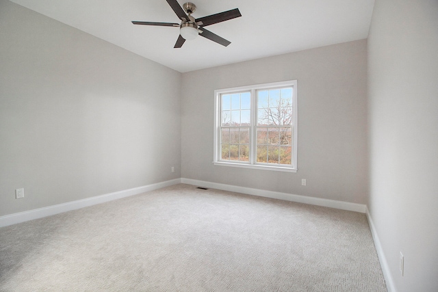 spare room featuring carpet flooring and ceiling fan