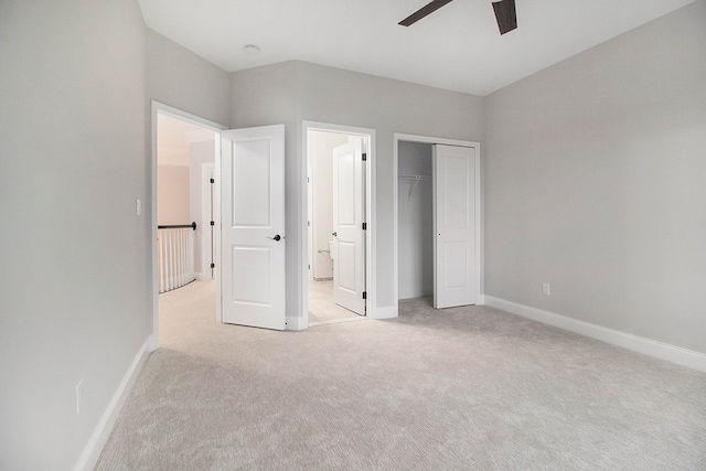 unfurnished bedroom featuring a closet, light colored carpet, and ceiling fan