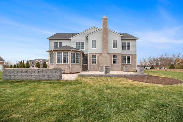 back of house with a lawn and a patio area