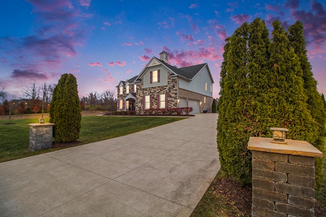 view of front facade with a lawn and a garage