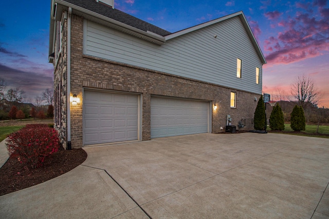 property exterior at dusk featuring a garage