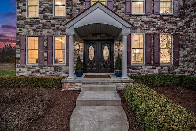 view of exterior entry at dusk