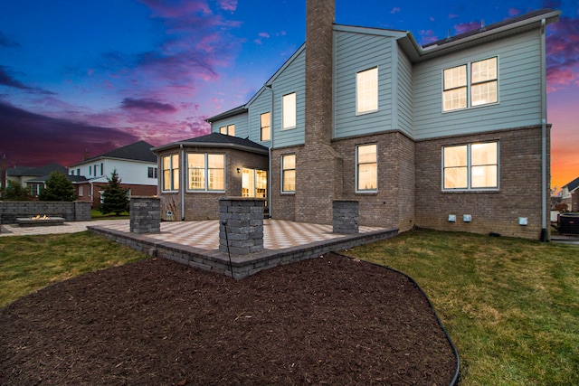 back house at dusk with a yard