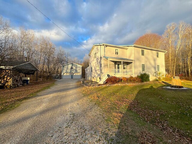 view of side of home with a lawn and a porch