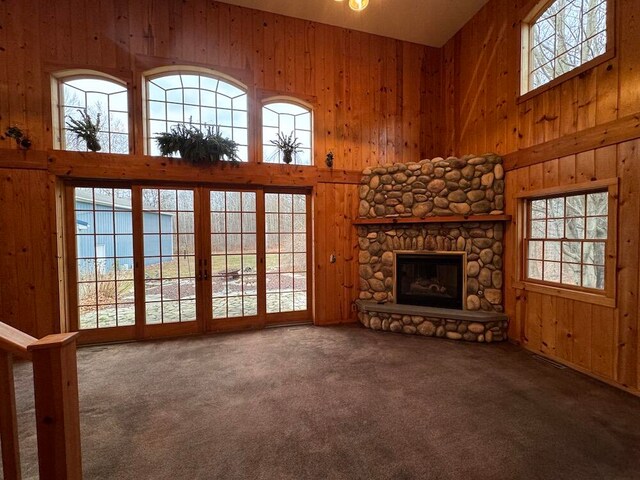 unfurnished living room with a towering ceiling and plenty of natural light