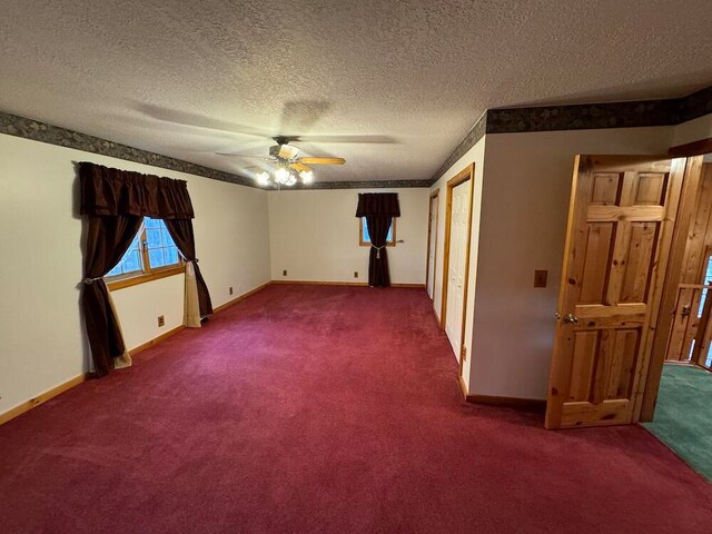 unfurnished room with ceiling fan, a textured ceiling, and carpet