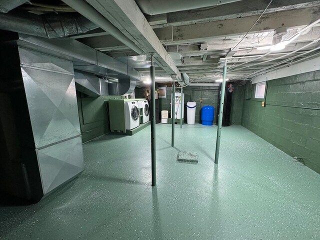 basement with washing machine and dryer and heating unit