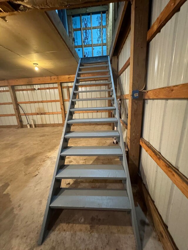 stairs featuring concrete floors