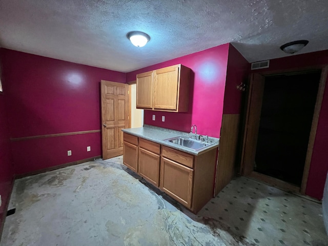 kitchen with a textured ceiling and sink