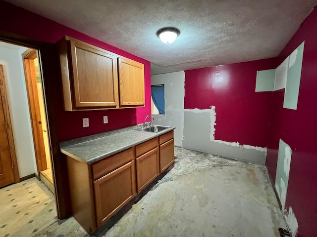 kitchen featuring a textured ceiling and sink