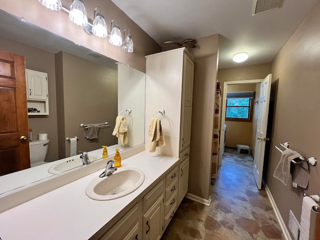 bathroom with vanity and toilet