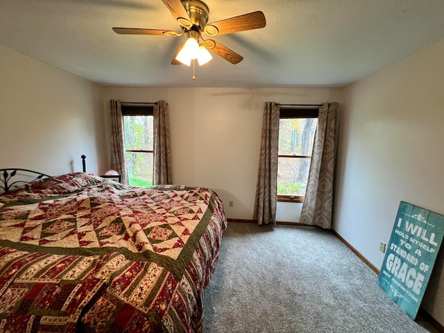 bedroom with carpet flooring, ceiling fan, and multiple windows