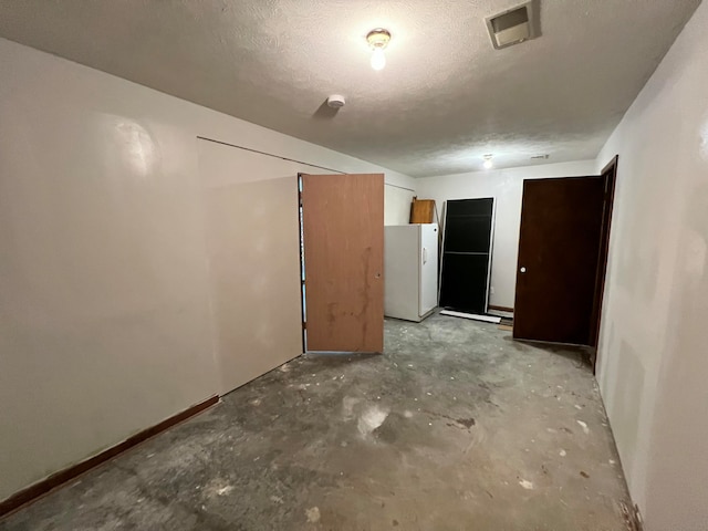 spare room featuring a textured ceiling