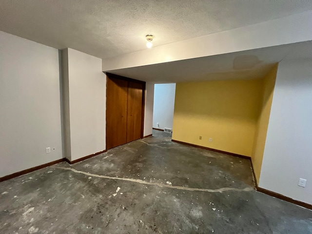 basement featuring a textured ceiling