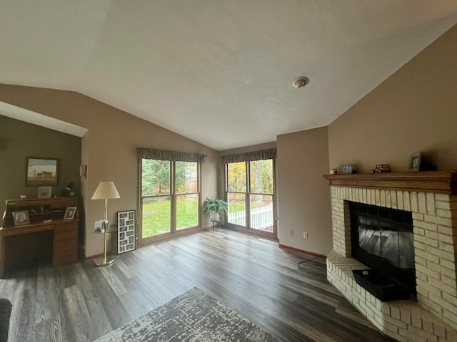 living room with a fireplace, wood-type flooring, a textured ceiling, and vaulted ceiling