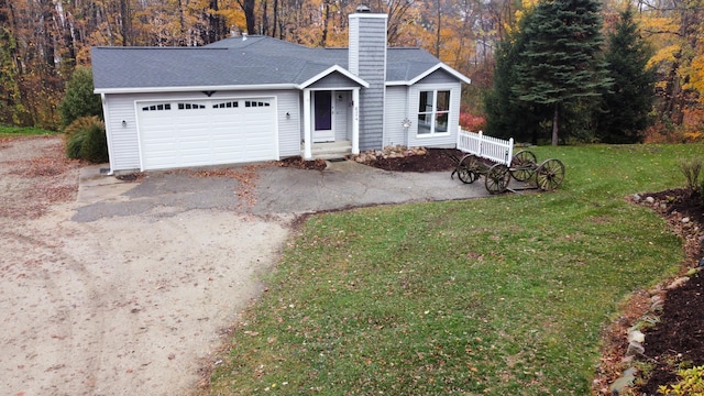 view of front of house with a garage and a front yard