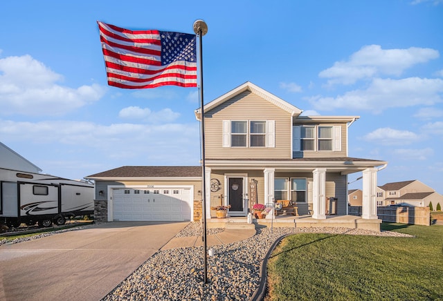 view of front of house featuring a garage, a front yard, and covered porch