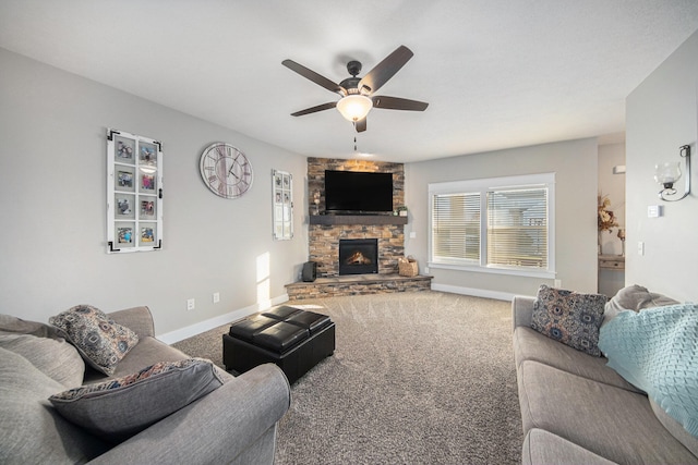 carpeted living room featuring ceiling fan and a fireplace