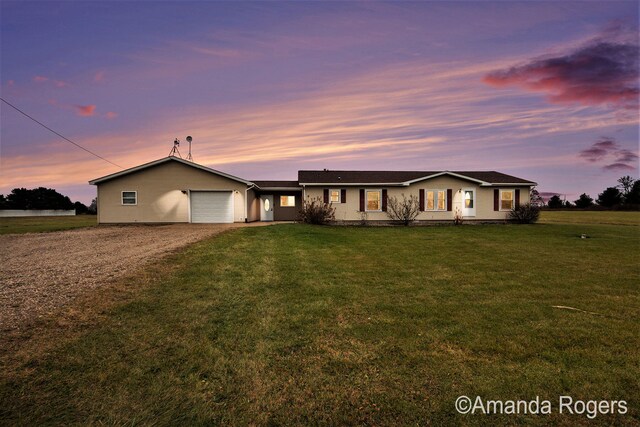 single story home with a yard and a garage