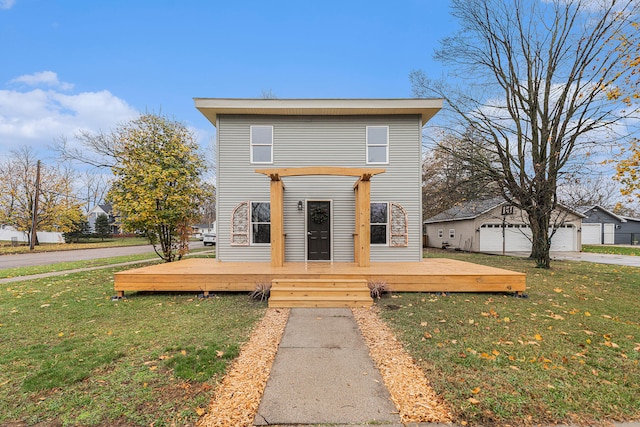 view of front facade with a deck, a pergola, a front lawn, a garage, and an outdoor structure