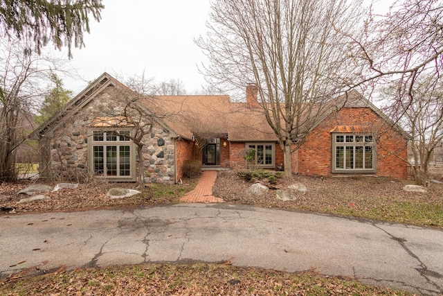 4489 Cranbrook Trl, Orchard Lake, MI 48323 - view of front facade featuring a chimney and brick siding
