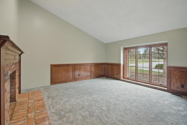 4489 Cranbrook Trl, Orchard Lake, MI 48323 - unfurnished living room with carpet, visible vents, vaulted ceiling, and a wainscoted wall