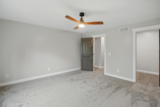 4489 Cranbrook Trl, Orchard Lake, MI 48323 - unfurnished bedroom with baseboards, a ceiling fan, a walk in closet, visible vents, and light colored carpet