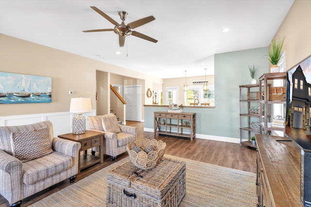 living room featuring hardwood / wood-style flooring and ceiling fan