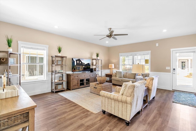 living room featuring hardwood / wood-style flooring and ceiling fan