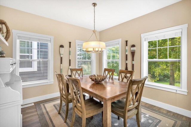 dining room with a chandelier and dark hardwood / wood-style floors