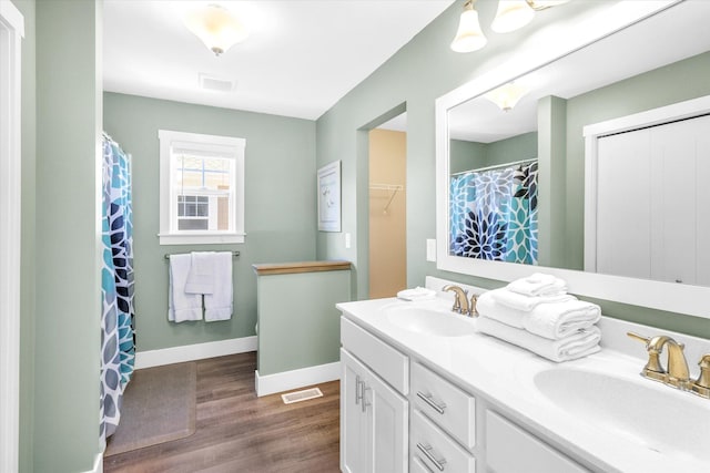 bathroom with hardwood / wood-style floors and vanity