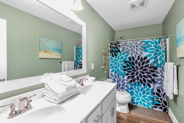 bathroom with hardwood / wood-style floors, vanity, toilet, and a shower with curtain