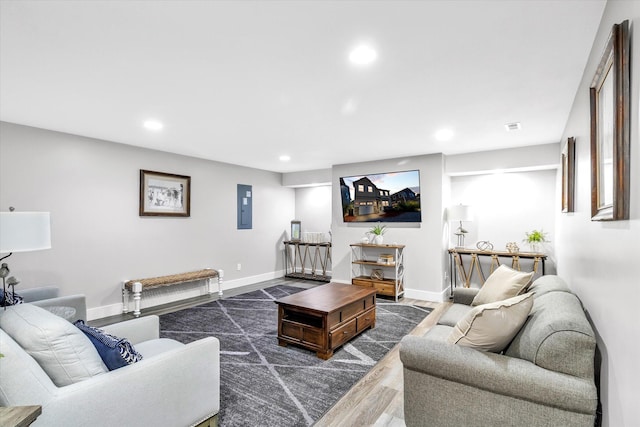 living room with electric panel and dark hardwood / wood-style flooring