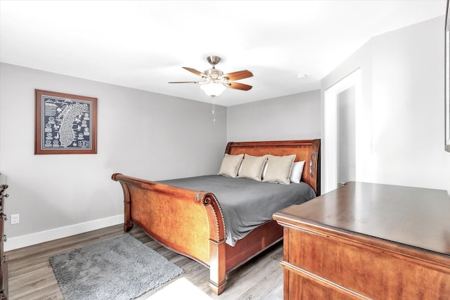 bedroom with hardwood / wood-style floors and ceiling fan