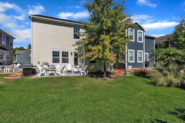 rear view of property with a patio and a yard