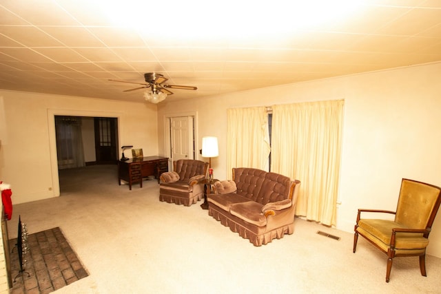 carpeted living room with ceiling fan