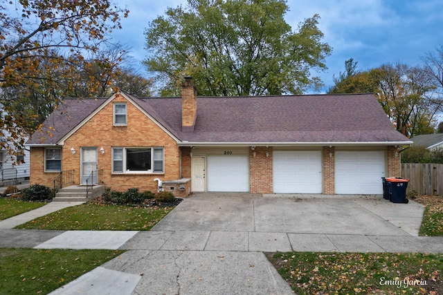 view of front of property featuring a front yard and a garage