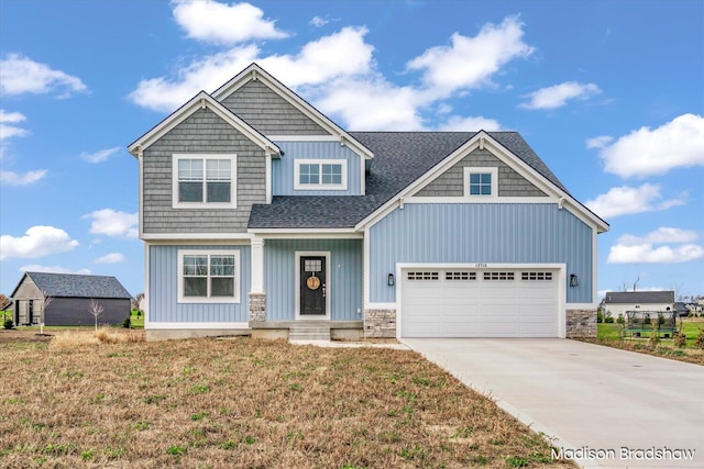 craftsman-style home featuring a garage and a front lawn