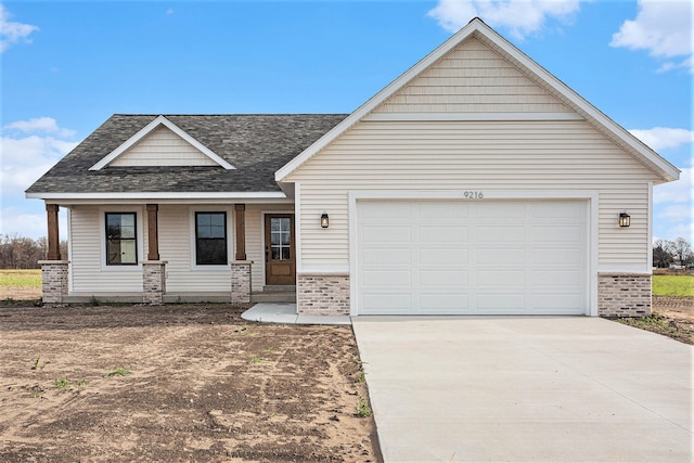 view of front of house with covered porch and a garage