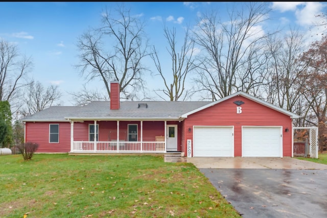 ranch-style house featuring covered porch, a front yard, and a garage