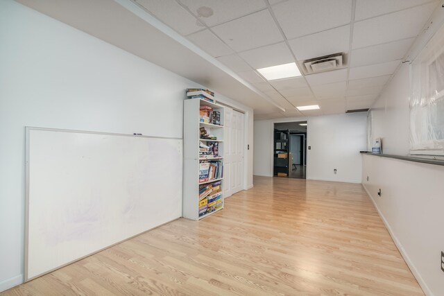 interior space with light hardwood / wood-style flooring and a drop ceiling