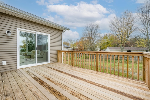 wooden terrace featuring a yard