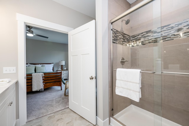 bathroom with walk in shower, vanity, and ceiling fan