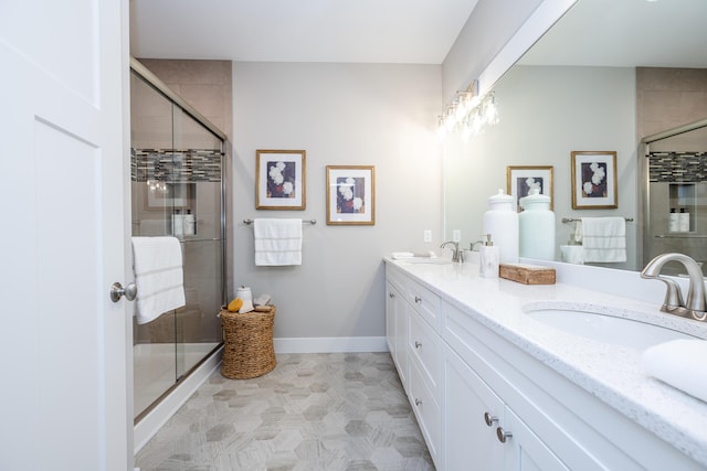 bathroom featuring vanity and a shower with door