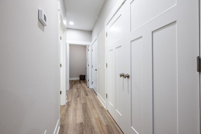 corridor with light wood-type flooring