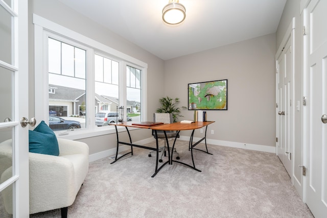 office area with french doors and light colored carpet