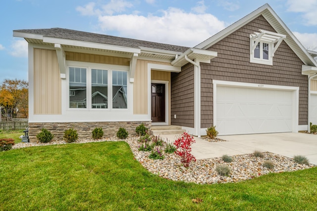 view of front of house featuring a garage and a front lawn