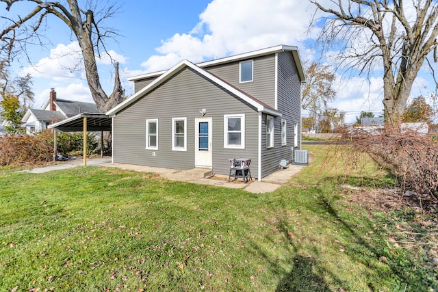 back of house featuring a carport, a yard, and cooling unit