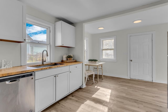 kitchen with dishwasher, white cabinets, light hardwood / wood-style flooring, and sink