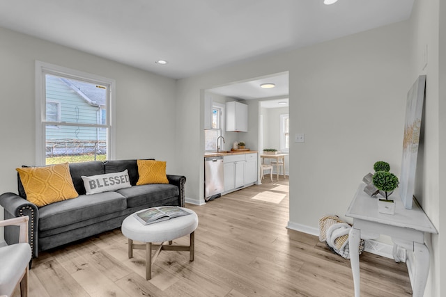 living room featuring light hardwood / wood-style floors and sink